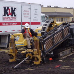 Construction worker operating heavy machinery on site.